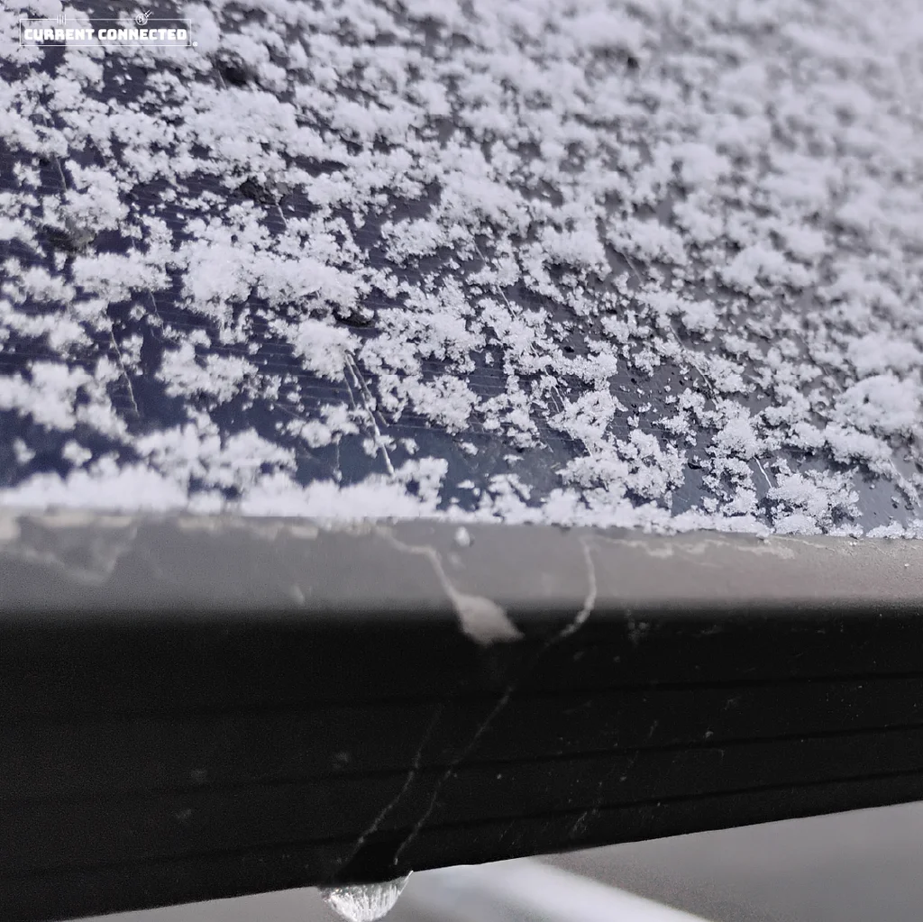 Close up image of snowflakes on a solar panel.